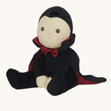 Olli Ella Vincent Vampire Dinky Dinkum doll. A soft vampire doll with a black cape with bat shaped glow in the dark details on the back. These soft toys are part of Olli Ella's Halloween collection available here at Babipur.