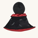 A view of the back of the Olli Ella Vincent Vampire Dinky Dinkum doll. A soft vampire doll with a black cape with bat shaped glow in the dark details on the back. These soft toys are part of Olli Ella's Halloween collection available here at Babipur.