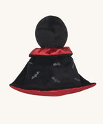 A view of the back of the Olli Ella Vincent Vampire Dinky Dinkum doll. A soft vampire doll with a black cape with bat shaped glow in the dark details on the back. These soft toys are part of Olli Ella's Halloween collection available here at Babipur.