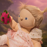 Olli Ella Willow dinkum doll holding the dragon fruit from the Olli Ella fairy food set.