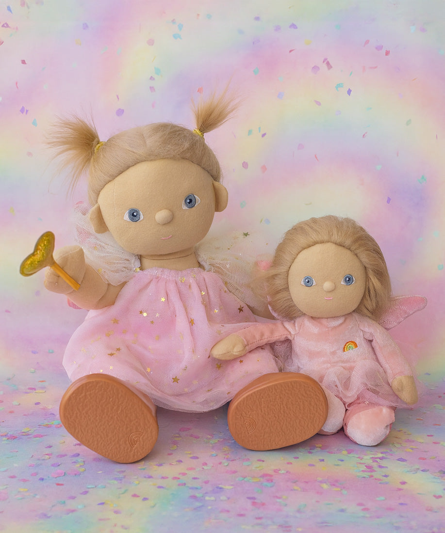 Olli Ella Willow dream dinkum doll sitting next to Fiona dinky dinkum doll against a dreamy background with confetti on the floor