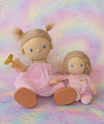 Olli Ella Willow dream dinkum doll sitting next to Fiona dinky dinkum doll against a dreamy background with confetti on the floor