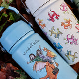 A blue and cream One Green Bottle stainless steel bottles on a pile of autumn leaves showing different Zog character designs