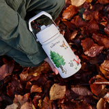 Child holding a One Green Bottle stainless steel water bottle in cream with Gruffalo characters above autumn leaves