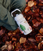 Child holding a One Green Bottle stainless steel water bottle in cream with Gruffalo characters above autumn leaves