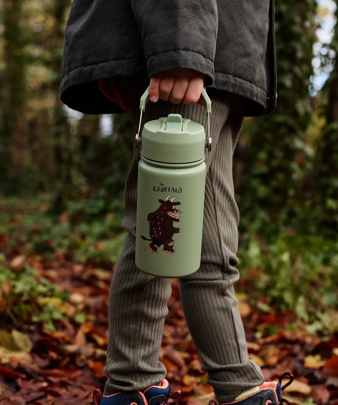 Child walking in the forest and carrying a Stainless steel Green bottle with a Gruffalo character 