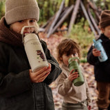Children standing in a forest and holding a One Green Bottle Stainless steel bottle showing a Gruffalo character
