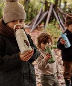 Children standing in a forest and holding a One Green Bottle Stainless steel bottle showing a Gruffalo character