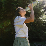 An adult enjoying a cool drink on a sunny day