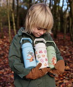 Child holding All 3 One Green Bottle collection bottles in the forest showing the different characters