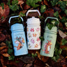 All 3 One Green Bottle collection bottles laid on a pike of autumn leaves showing the different Zog characters