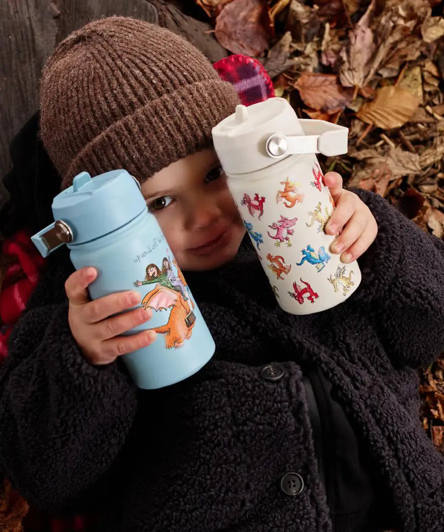 Child holding a blue and cream One Green Bottle stainless steel water bottles showing different Zog characters