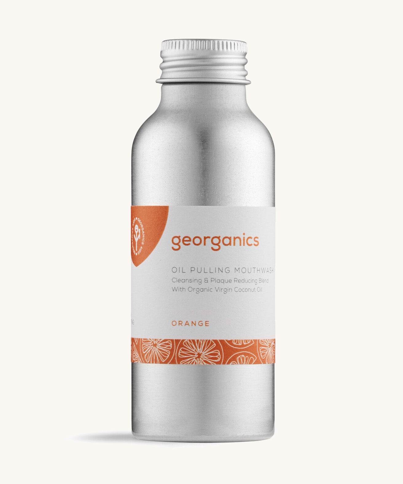 A bottle of the Georganics orange oil pulling mouthwash on a cream background