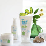 Organic Babies Softening Baby Lotion 150ml in front of a green vase with leaves in. 