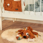 A child playing with the Roommate Activity Dog toy