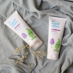 Organic Children Lavender Burst Shampoo and conditioner on a piece of moss green coloured linen. 