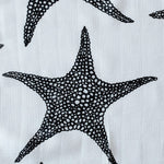 The Etta Loves XL Starfish muslin cloth tucked into a black bag