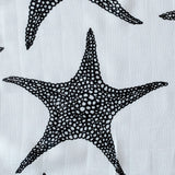 The Etta Loves XL Starfish muslin cloth tucked into a black bag