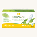 Regular tampons in a box on a cream background.