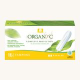 Regular tampons in a box on a cream background.