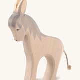 A grey wooden standing Ostheimer figure on a cream background.