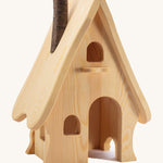 A wooden Ostheimer fairy tale dolls house on a cream background.
