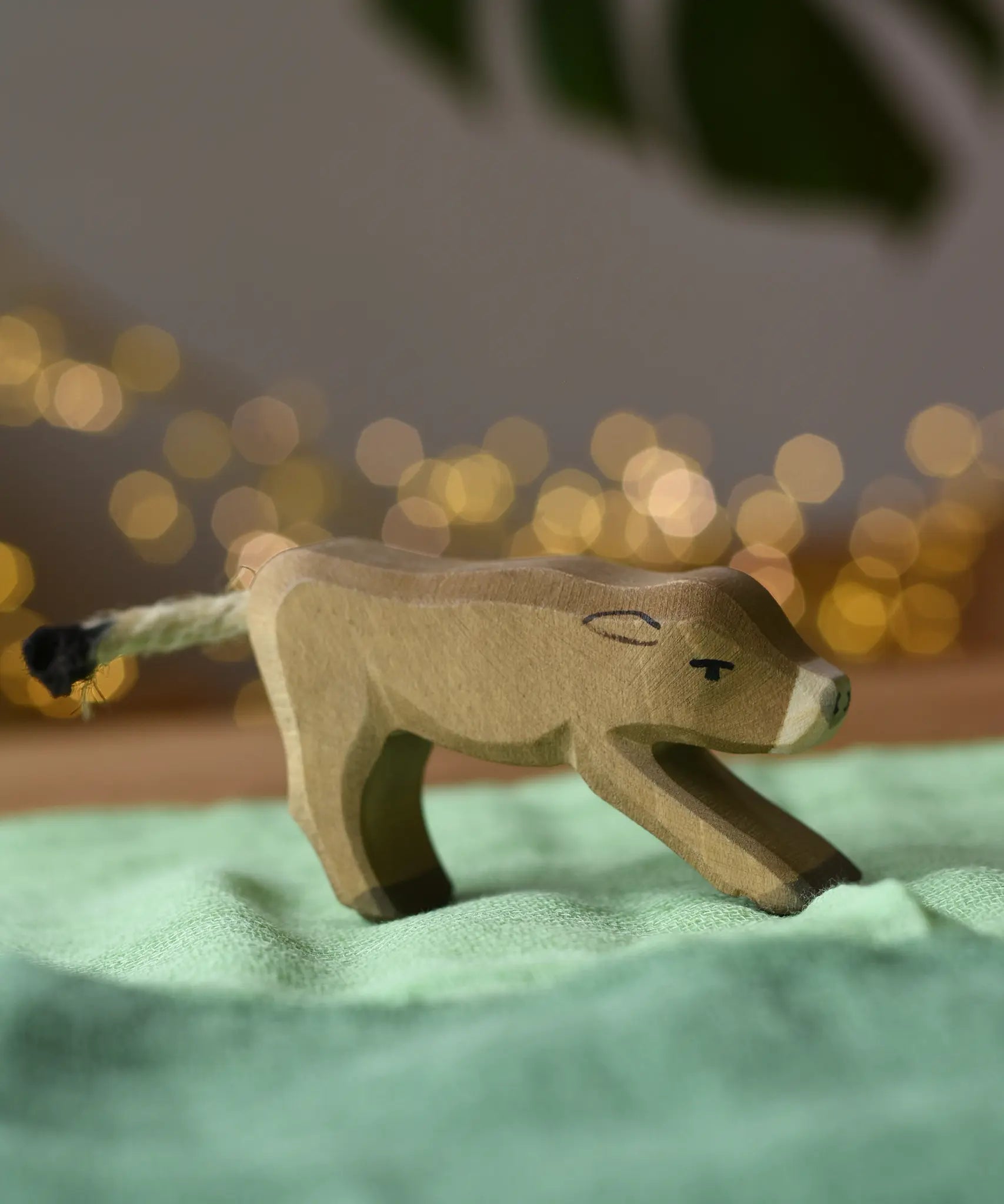 Ostheimer alp calf drinking placed on a green cotton play cloth.