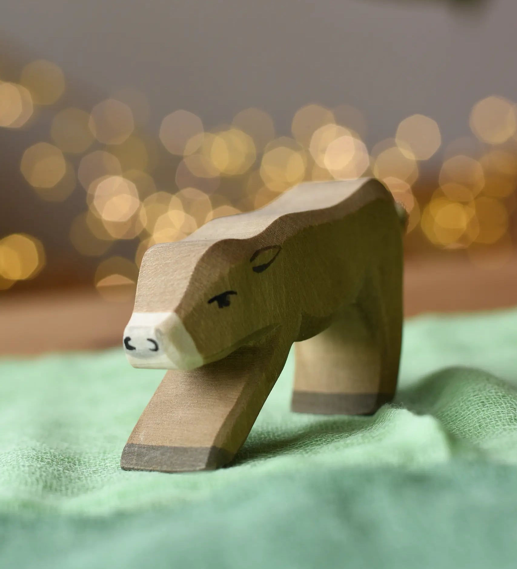Ostheimer alp calf drinking placed on a green cotton play cloth.