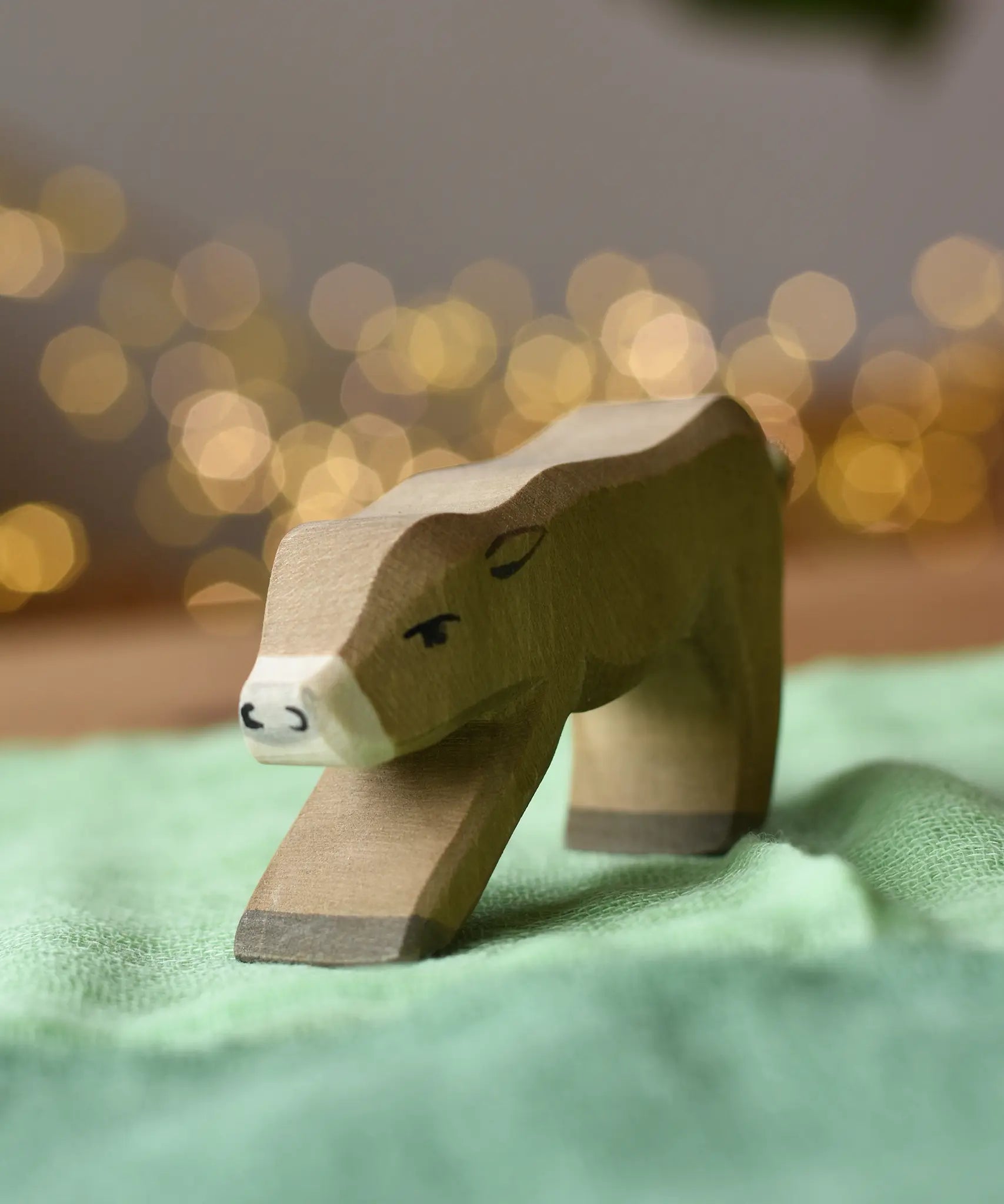 Ostheimer alp calf drinking placed on a green cotton play cloth.