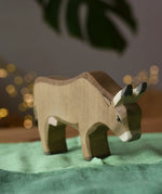 Ostheimer alp cow eating placed on green cotton play cloths. 