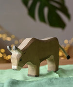 Ostheimer alp cow eating placed on green cotton play cloths. 