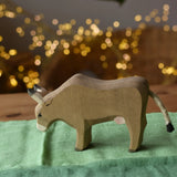 Ostheimer alp cow eating placed on green cotton play cloths. 