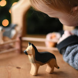 A child playing with an Ostheimer German shepherd dog wooden toy figure. These wooden figures are part of a wide range of expertly hand crafted wooden toys here at Babipur. 