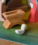 Ostheimer baby jesus and crib wooden toy nativity figure in a small world play scene. 