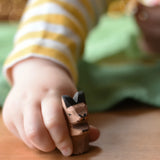 Ostheimer baby kangaroo handmade wooden toy figure in a child's hand.