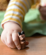 Ostheimer baby kangaroo handmade wooden toy figure in a child's hand.