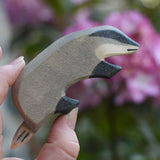 An Ostheimer badger wooden toy figure with it's head facing downwards. Check out our full range of expertly crafted, handmade wooden toy figures here at Babipur.