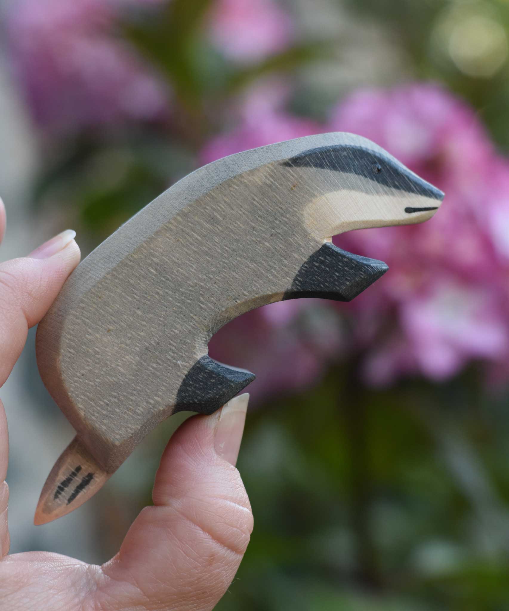 An Ostheimer badger wooden toy figure with it's head facing downwards. Check out our full range of expertly crafted, handmade wooden toy figures here at Babipur.