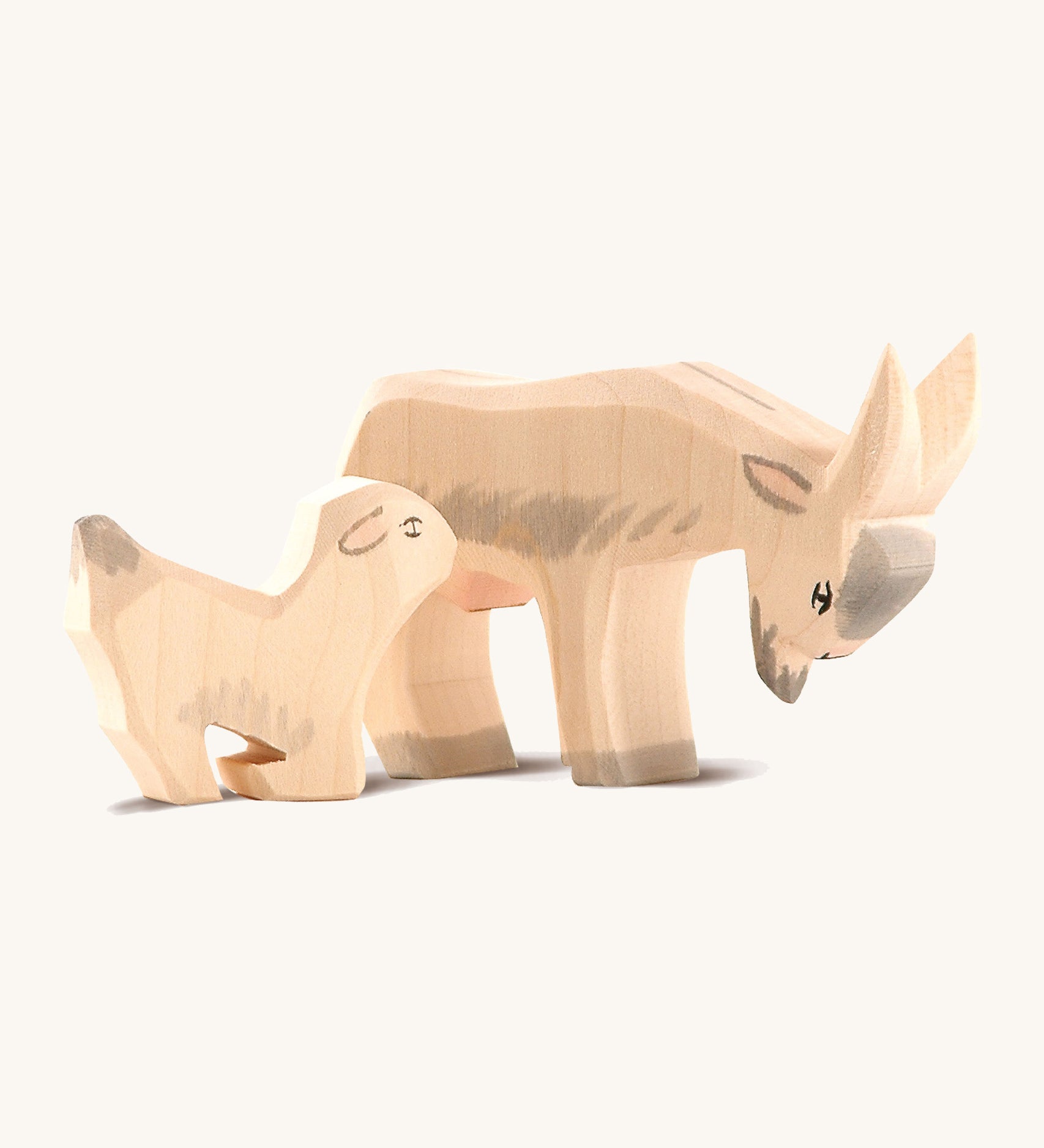 Ostheiemer handmade and hand painted goat kid wooden figure next to the drinking Billy goat figure.