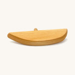 A wooden bird perch on a cream background