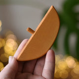 Ostheimer bird perch for nativity stable in an adult's hand. 