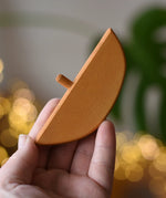 Ostheimer bird perch for nativity stable in an adult's hand. 