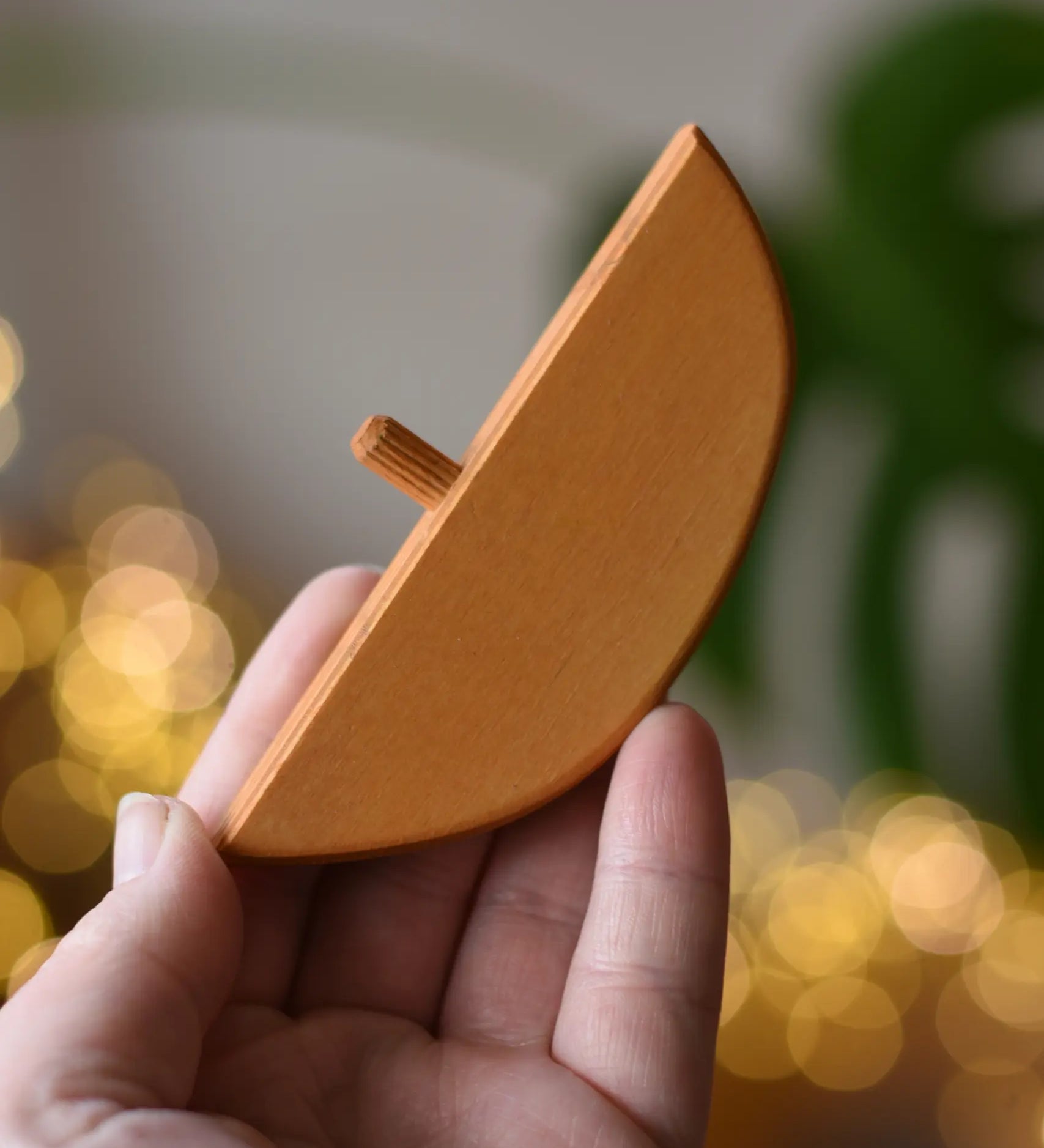 Ostheimer bird perch for nativity stable in an adult's hand. 