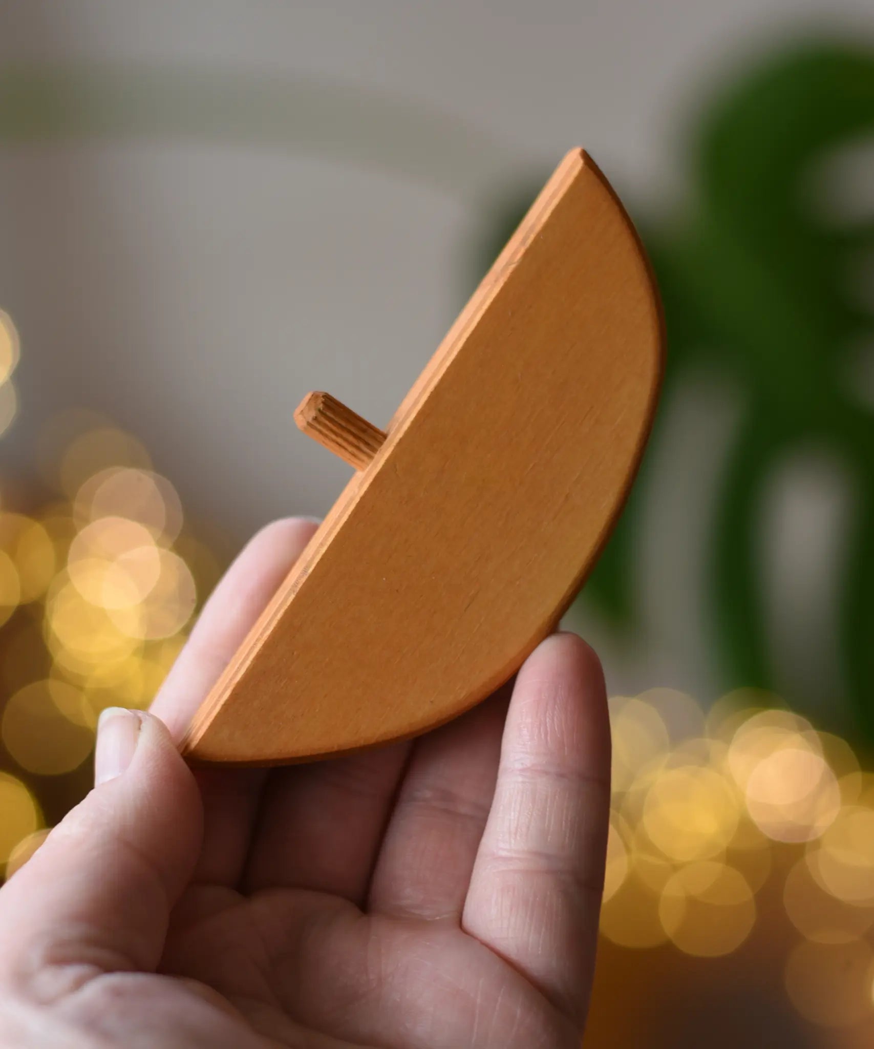 Ostheimer bird perch for nativity stable in an adult's hand. 