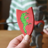 Red Ostheimer black knight shield with green dragon in an adult's hand. 