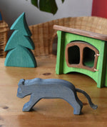 Ostheimer black panther placed in a small world play set up with the small spruce tree and hutch. 