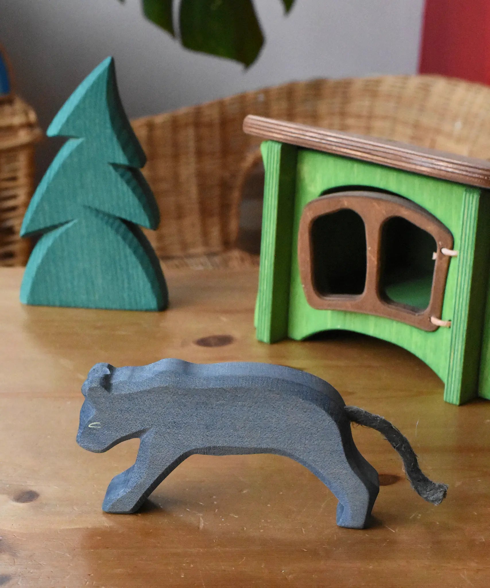 Ostheimer black panther placed in a small world play set up with the small spruce tree and hutch. 