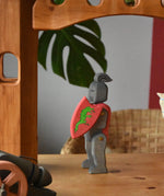 Ostheimer black riding knight handmade wooden toy figure with shield and long sword placed under the castle bride attached to towers.