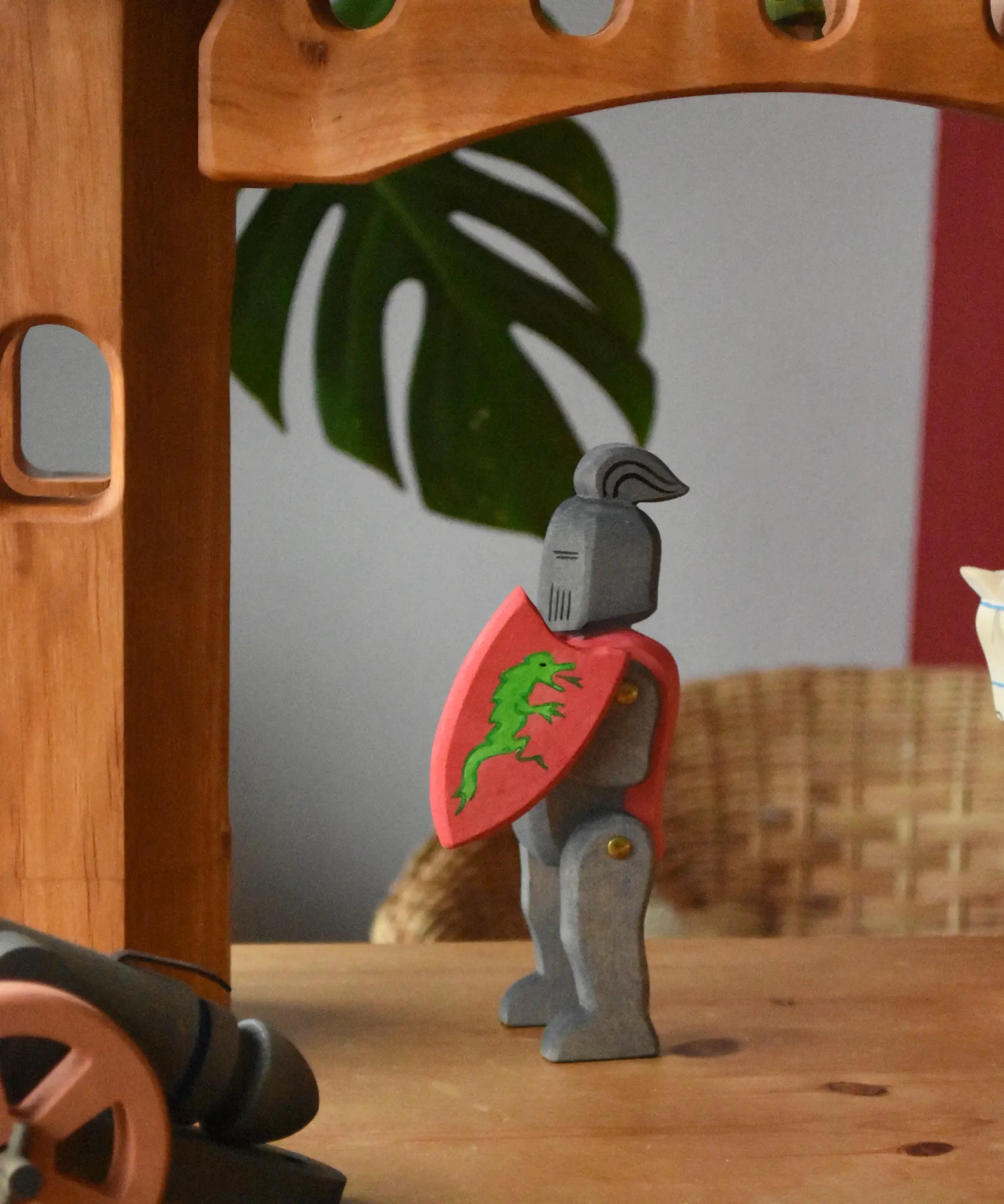 Ostheimer black riding knight handmade wooden toy figure with shield and long sword placed under the castle bride attached to towers.