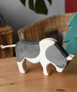 Ostheimer black and white ox wooden toy figure placed on a wooden surface in the Babipur playroom.